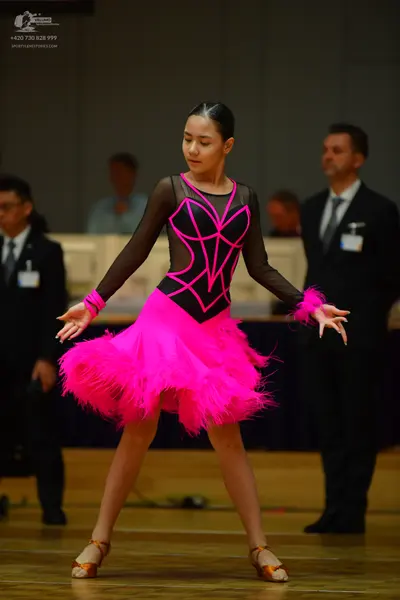 Dancesport competitor: Female dancer: hot pink and black Latin dance dress with pink fringe/feathers on