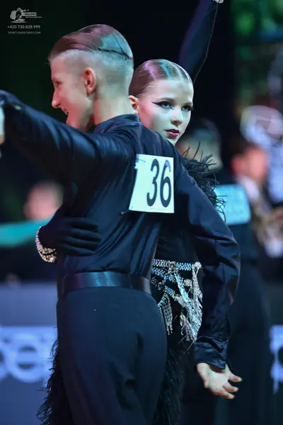 Dancesport competitor: Male dancer: black long-sleeved shirt and black trousers