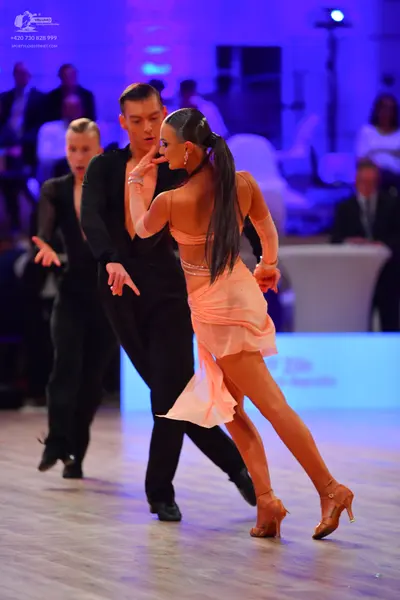 Dancesport competitor: Man on the left: black long-sleeved shirt and black trousers
