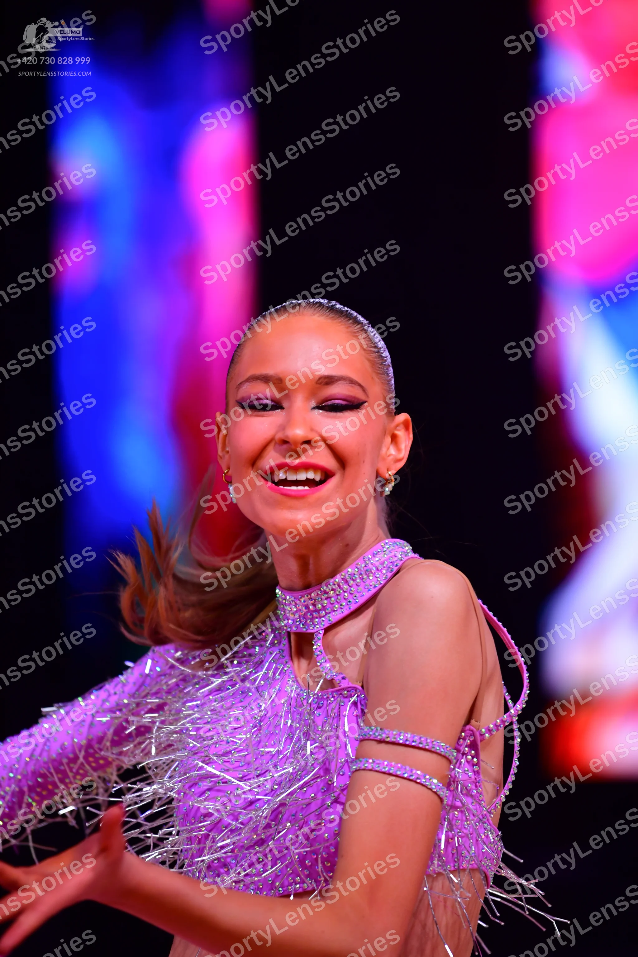 Dancesport competitor: Female dancer: light purple latin dress covered in sequins and crystals, with lo