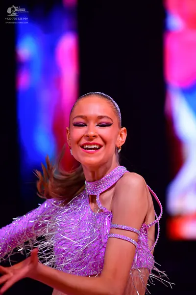 Dancesport competitor: Female dancer: light purple latin dress covered in sequins and crystals, with lo