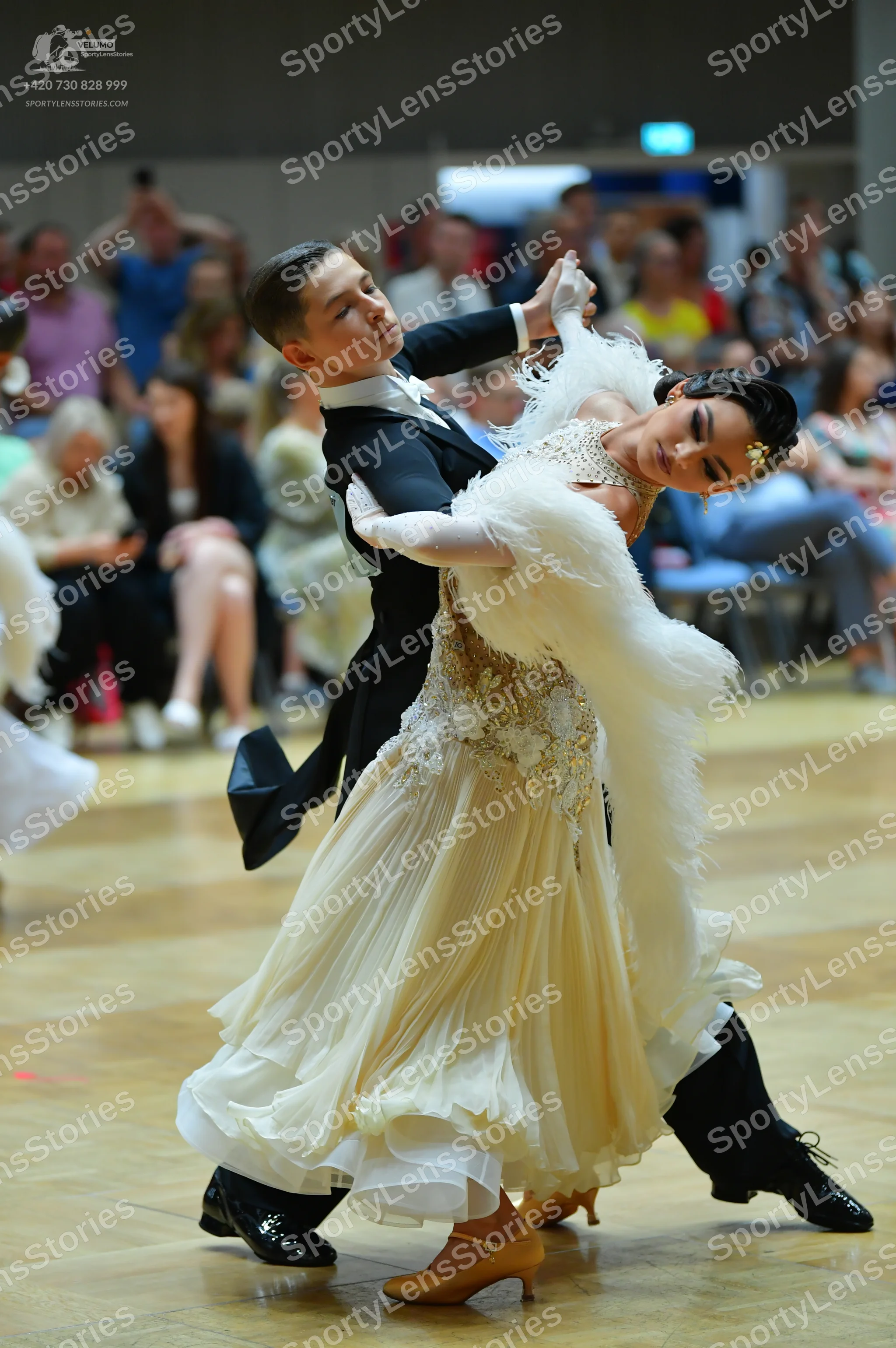 Dancesport competitor: Male dancer: black ballroom suit with a white shirt and white bowtie