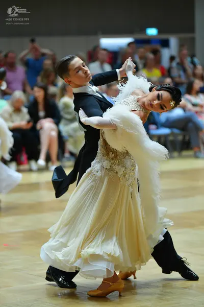 Dancesport competitor: Male dancer: black ballroom suit with a white shirt and white bowtie