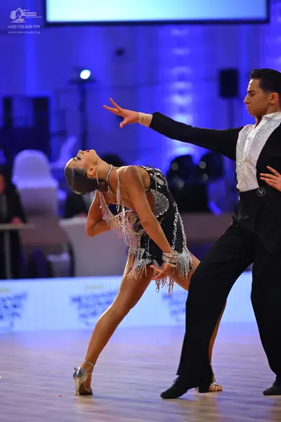 Dancesport competitor: Male dancer: black suit with a white textured or patterned front panel