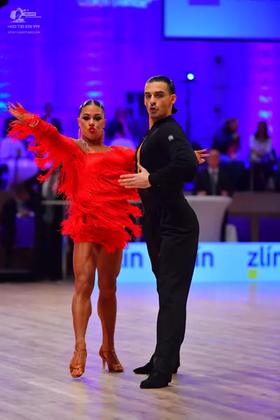 Dancesport competitor: Female dancer: red Latin dress with fringe