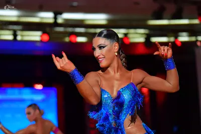 Dancesport competitor: Female dancer: bright blue Latin dance dress with blue sequins and fringe-like t