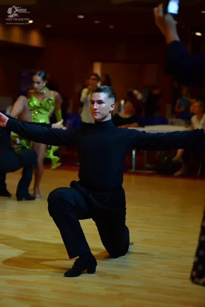 Dancesport competitor: Male dancer: black long-sleeved turtleneck and black trousers