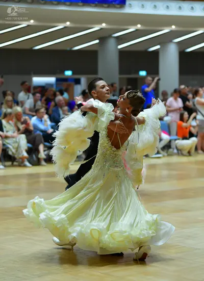 Dancesport competitor: Male dancer: black suit with a white shirt