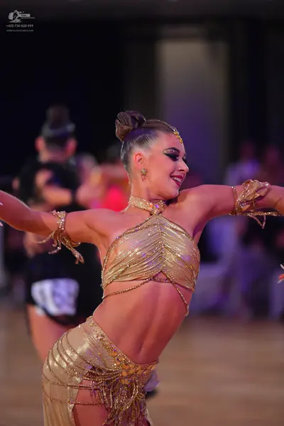 Dancesport competitor #69: Female dancer: gold latin dance two-piece costume with sequins and metallic frin
