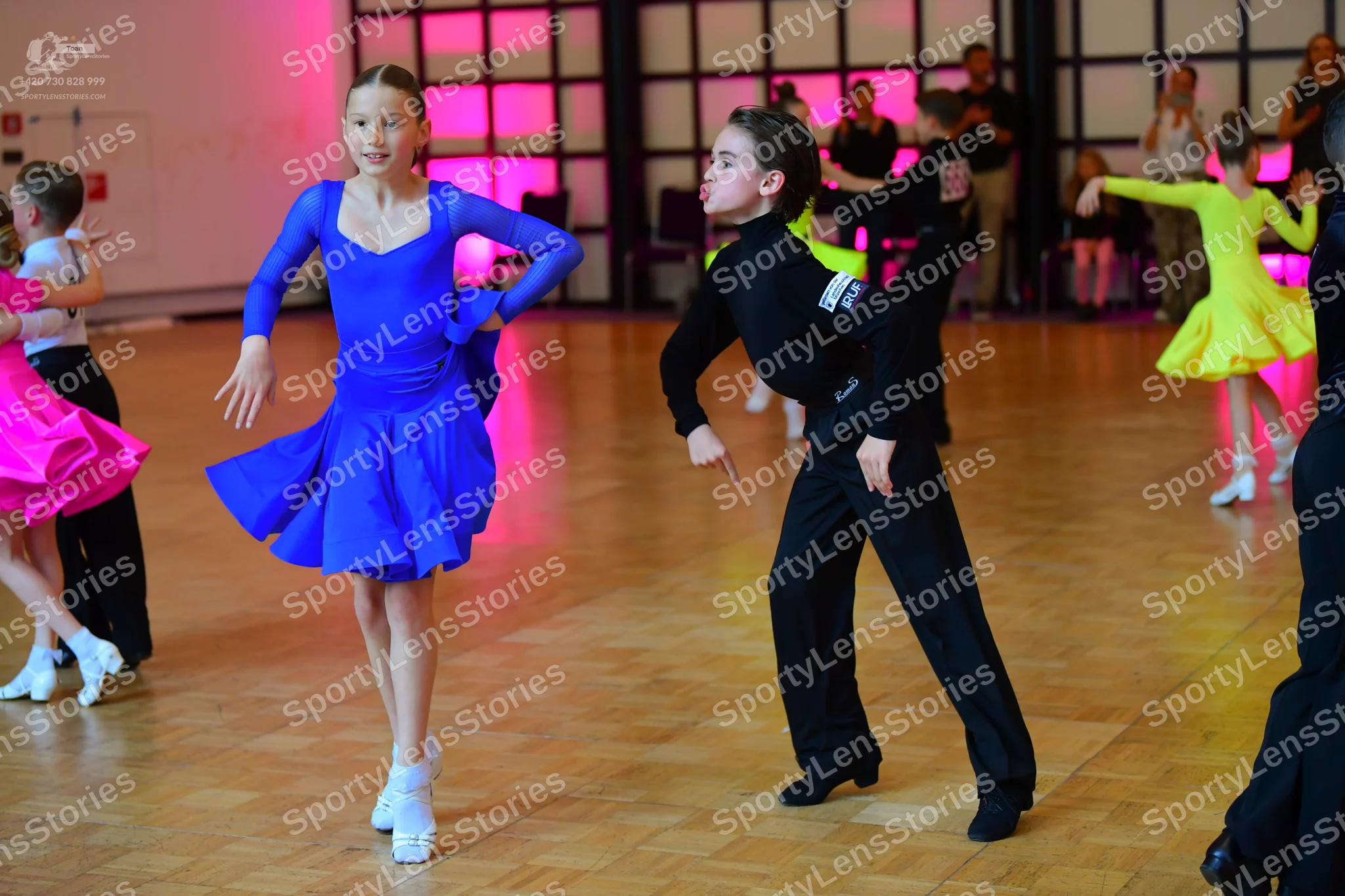 Dancesport competitor: Female dancer: blue long-sleeved latin dress with a flared skirt