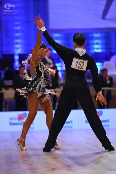 Dancesport competitor: Male dancer: black long-sleeved shirt and black trousers