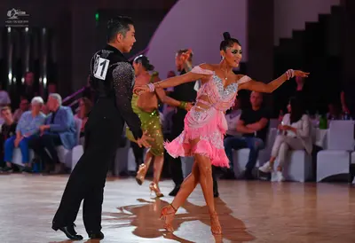Dancesport competitor: Male dancer: black long-sleeved shirt with silver sequin detail on the shoulder 