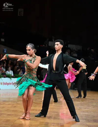 Dancesport competitor: Female dancer: green sequined Latin dress with fringe