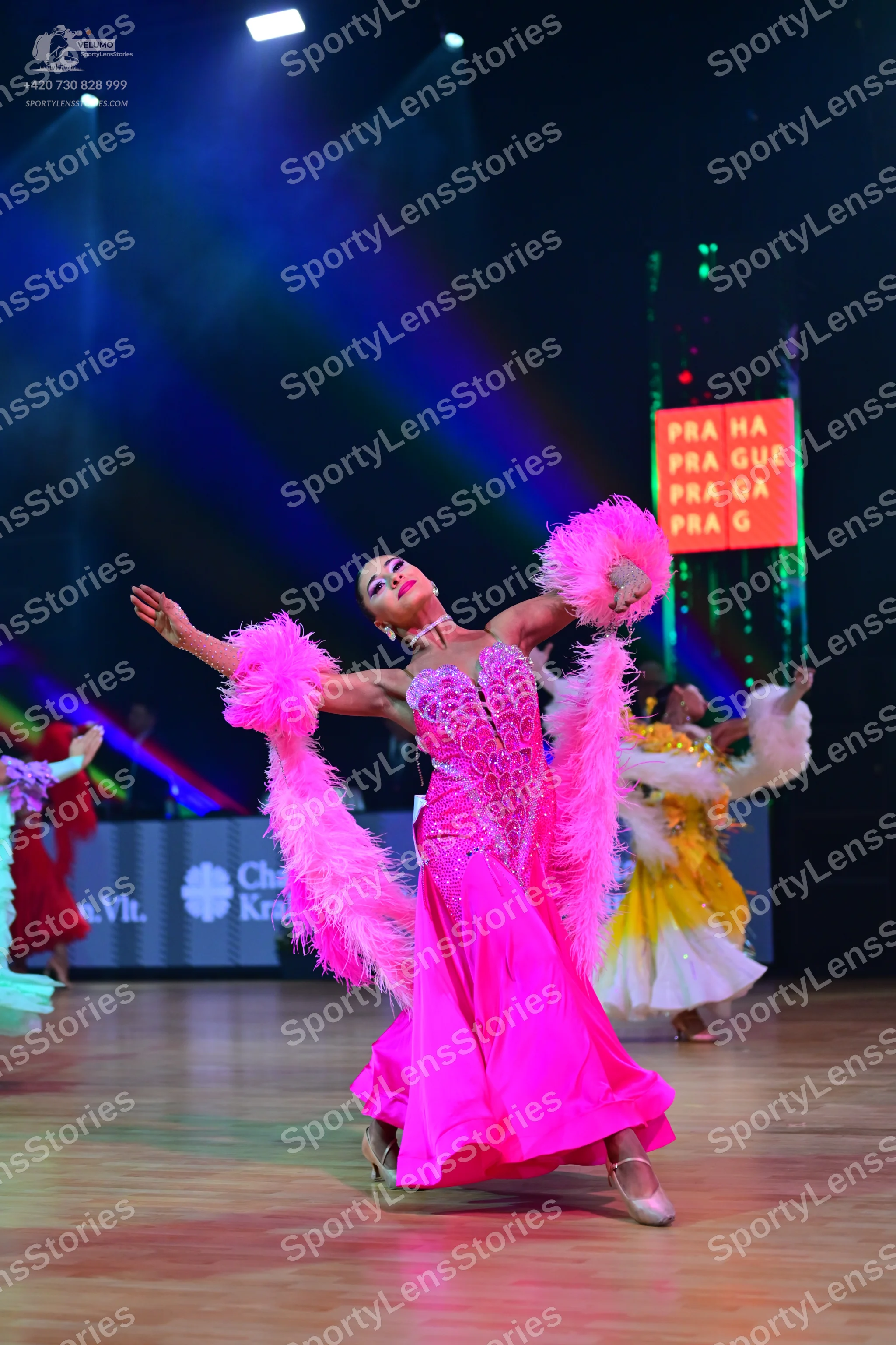 Dancesport competitor: Lead female dancer: bright pink satin ballgown with a heavily embellished crysta