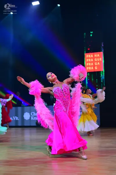 Dancesport competitor: Lead female dancer: bright pink satin ballgown with a heavily embellished crysta