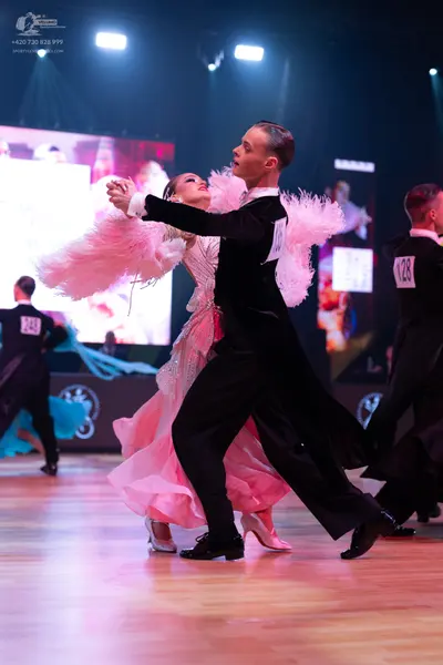 Dancesport competitor: Male dancer: black ballroom suit with a white shirt