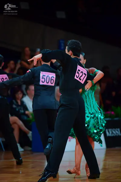 Dancesport competitor: Male dancers: black and dark grey suits, and a black shirt with black trousers