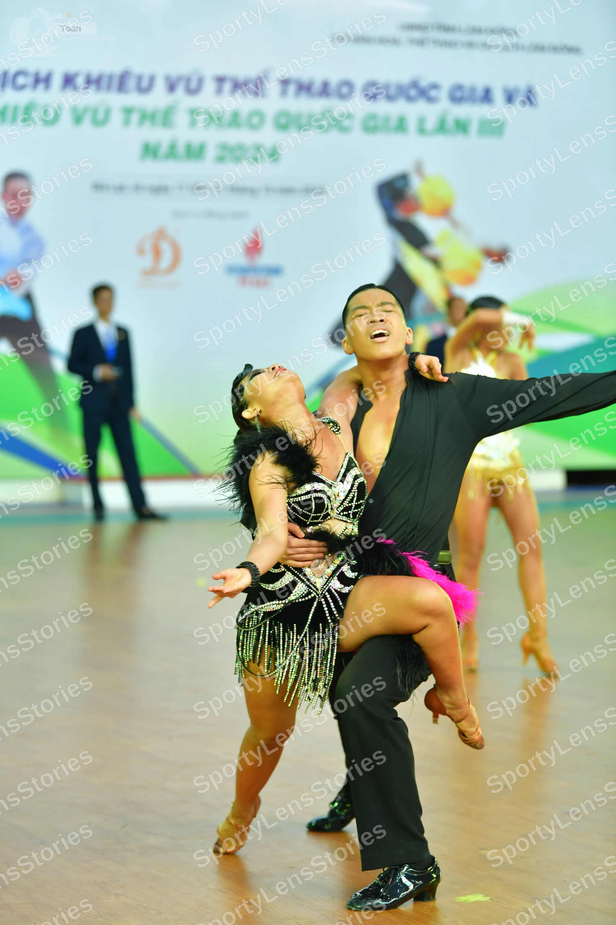 Dancesport competitor: ** Black suit with a white satin jacket and trousers