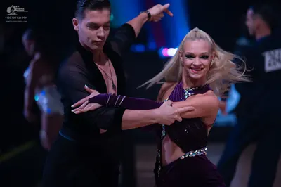 Dancesport competitor: Male dancer: black long-sleeved shirt and black trousers