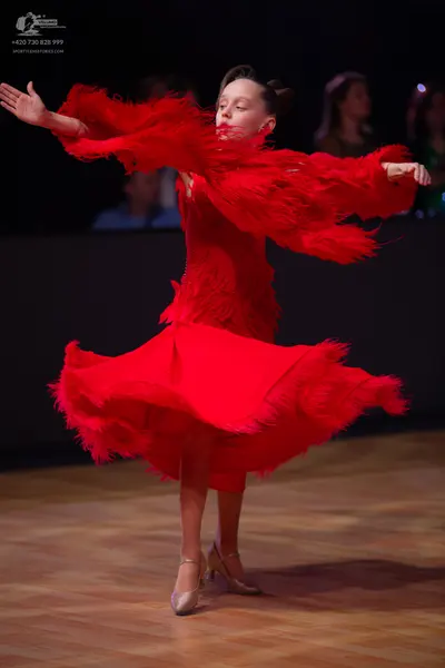 Dancesport competitor: Female dancer: red latin dress with fringe