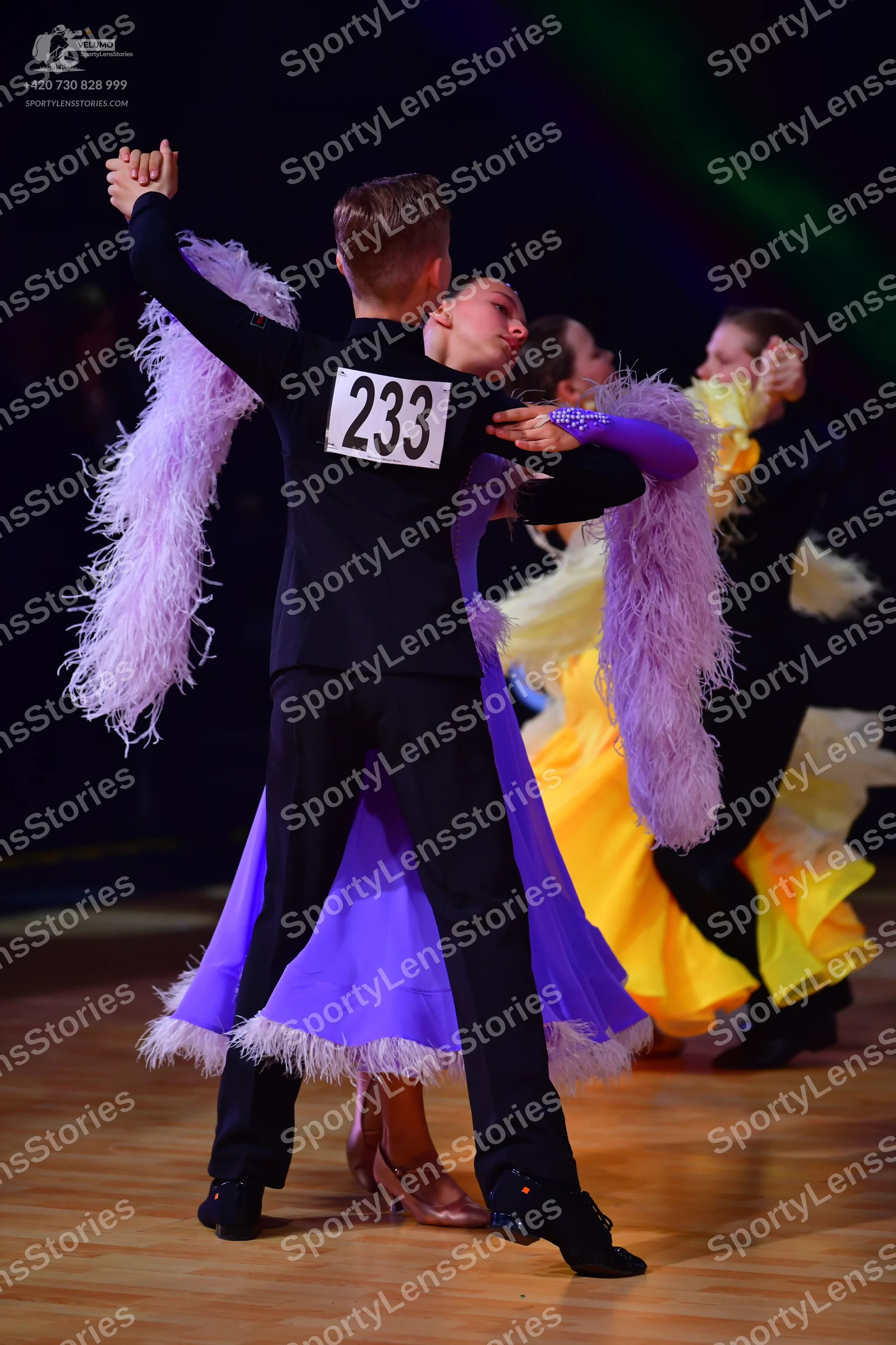 Dancesport competitor: Male dancer (foreground): black suit