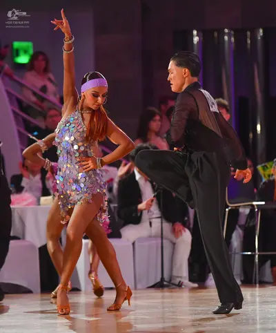 Dancesport competitor: Female dancer: silver sequined Latin dress with a fringe-like sequin hem, lavend