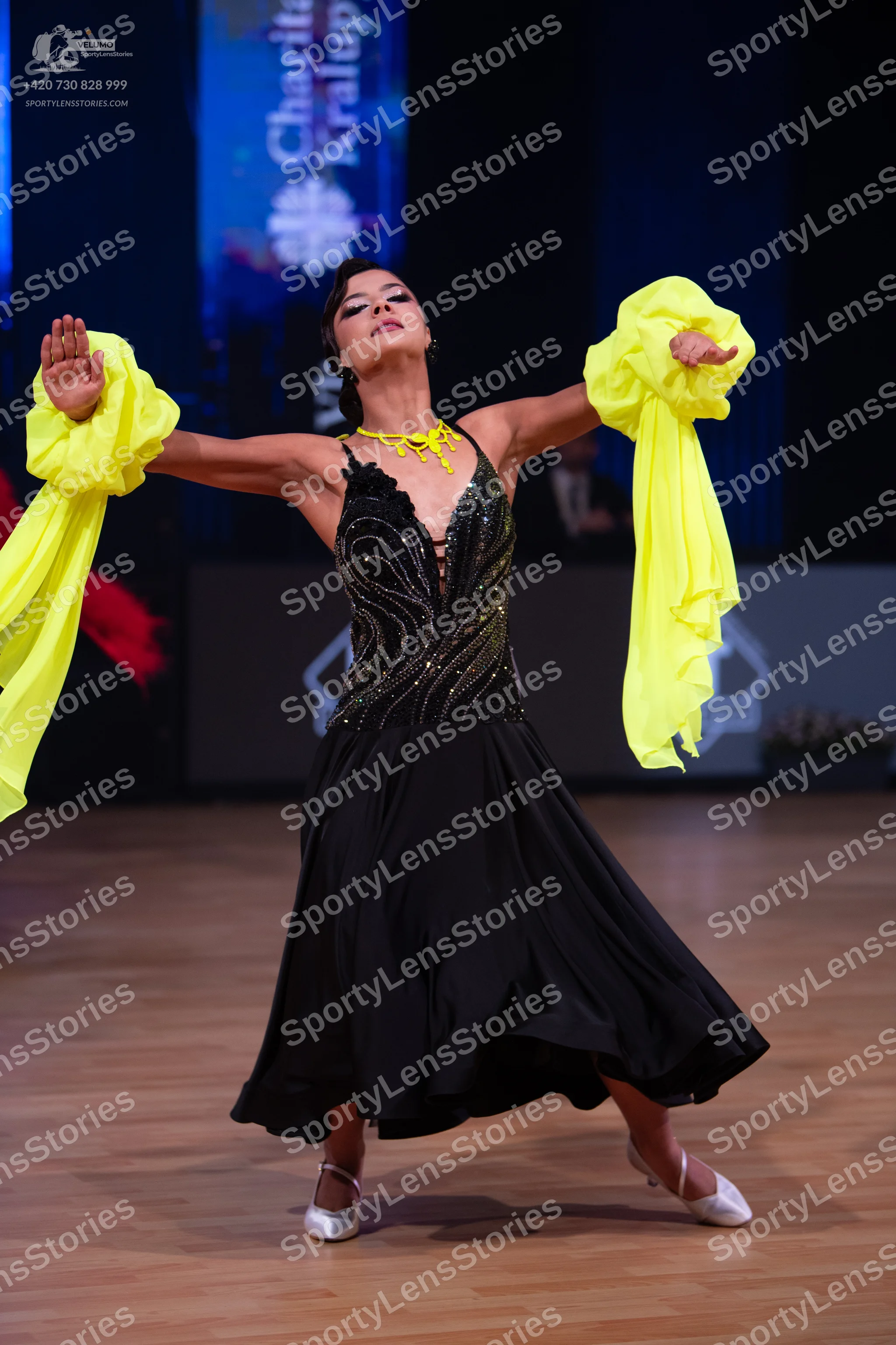 Dancesport competitor: Female dancer: black ballroom dress with a sequined bodice and large, voluminous