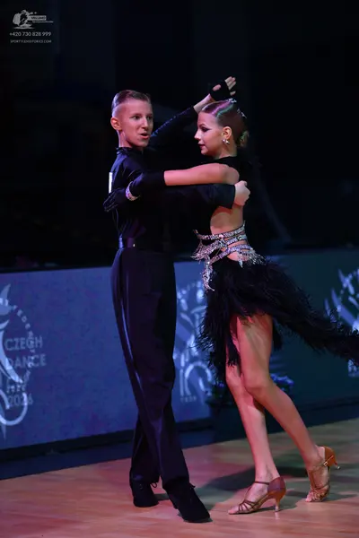 Dancesport competitor: Male dancer: black long-sleeved shirt and black trousers