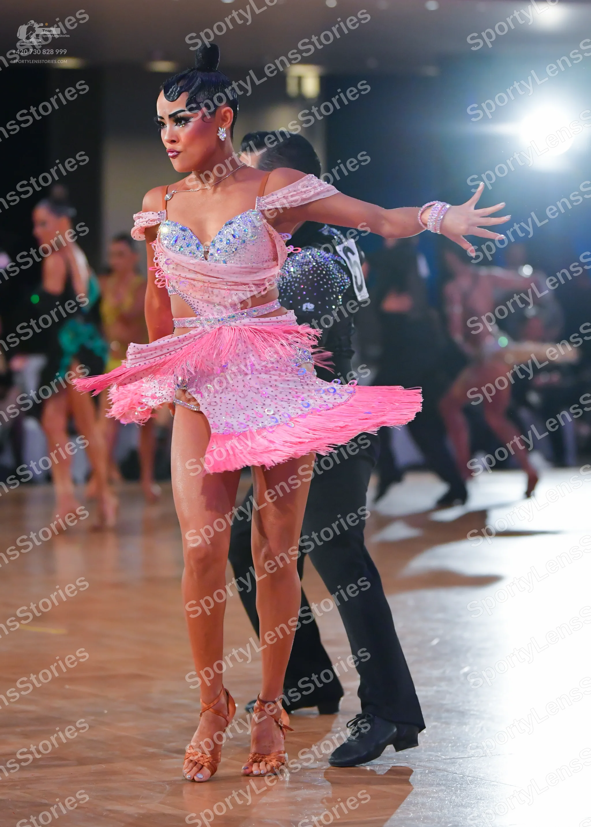 Dancesport competitor: Main female dancer: pink Latin dance dress with a sequined bodice and a skirt fe
