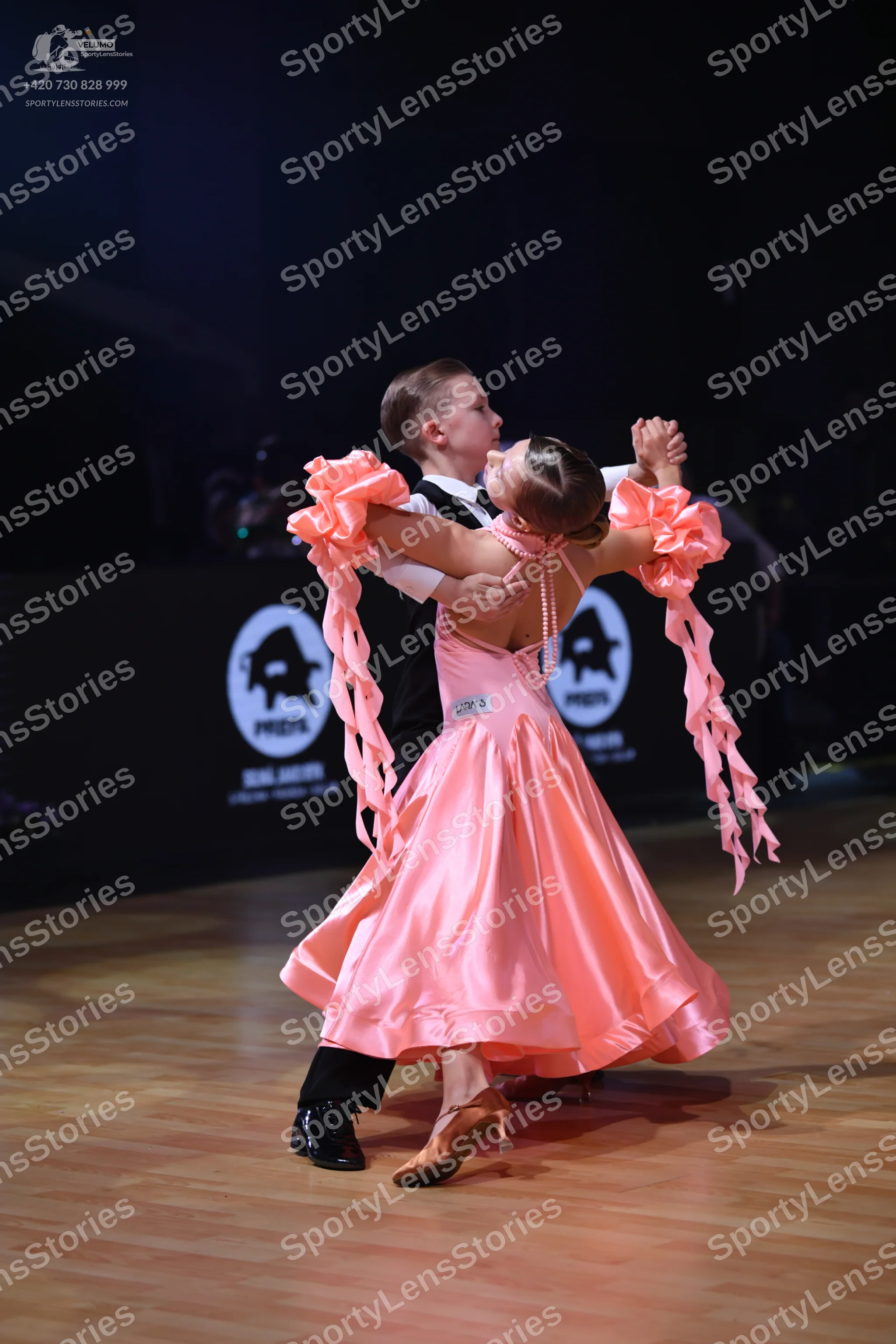 Dancesport competitor: Male dancer: black waistcoat, white shirt, and black trousers