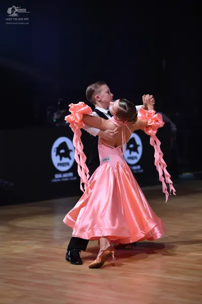 Dancesport competitor: Male dancer: black waistcoat, white shirt, and black trousers
