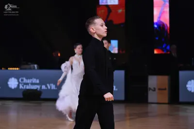 Dancesport competitor: Male dancer: black long-sleeved shirt and trousers