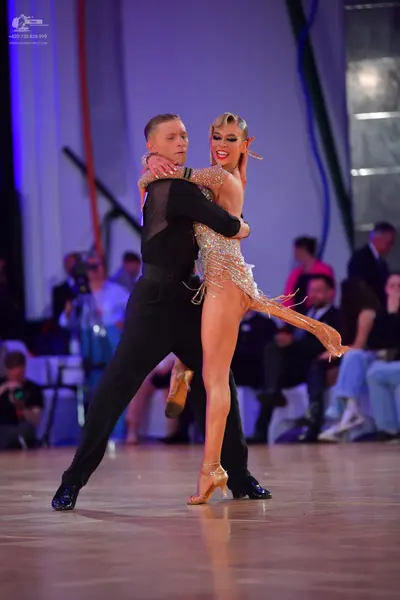 Dancesport competitor: Male dancer: black long-sleeved shirt and black trousers