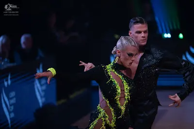 Dancesport competitor: Male dancer: black long-sleeved shirt with small shimmering embellishments