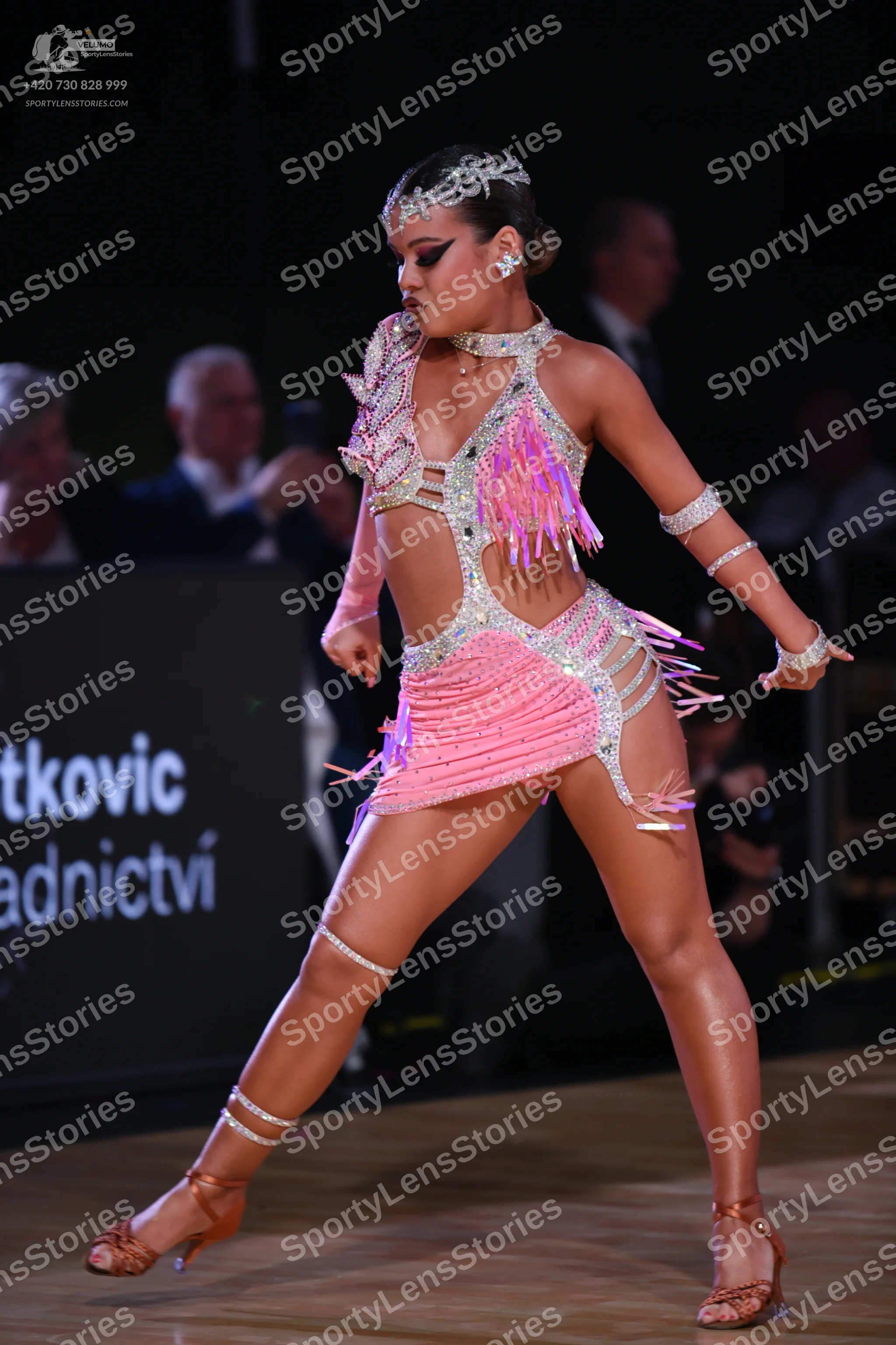Dancesport competitor: Female dancer: pink latin dress with silver sequins and pink fringe, wearing a s