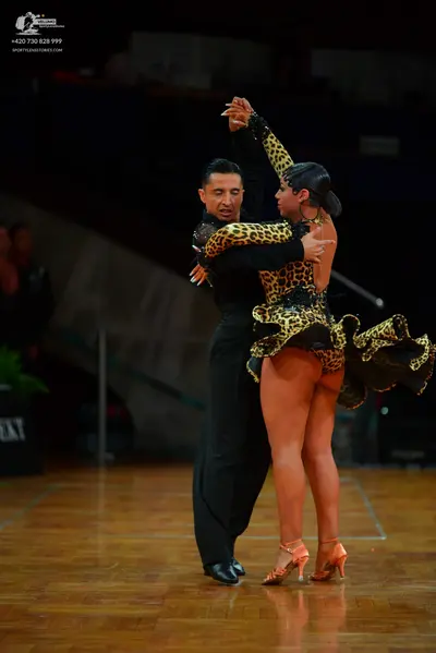 Dancesport competitor: Male dancer: black long-sleeved shirt and black trousers