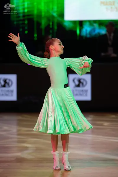 Dancesport competitor: Female dancer: light green, iridescent satin-like long-sleeved dress with a plea