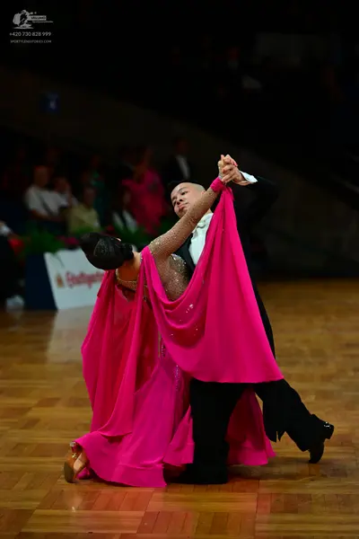 Dancesport competitor: Male dancer: black suit with a white shirt and black bow tie