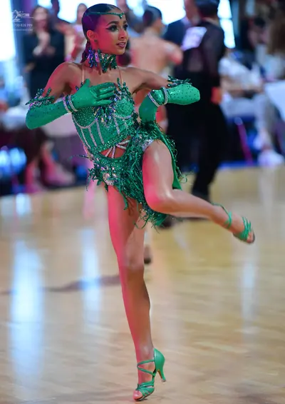 Dancesport competitor: Female dancer: emerald green latin dance dress with sequins, beads, and fringe; 
