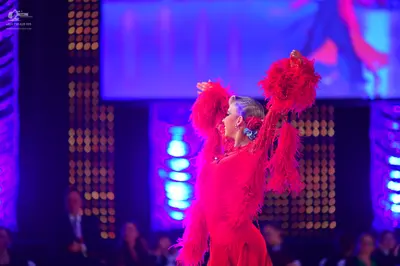 Dancesport competitor: Female dancer: red Latin dress with long, voluminous fringe