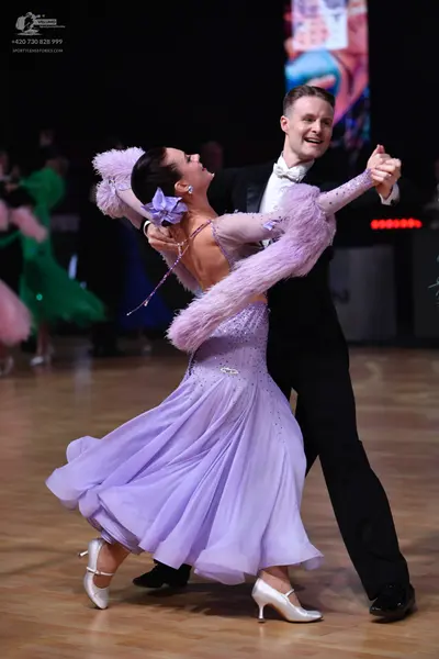 Dancesport competitor: Male dancer: black suit with a white shirt and white bowtie