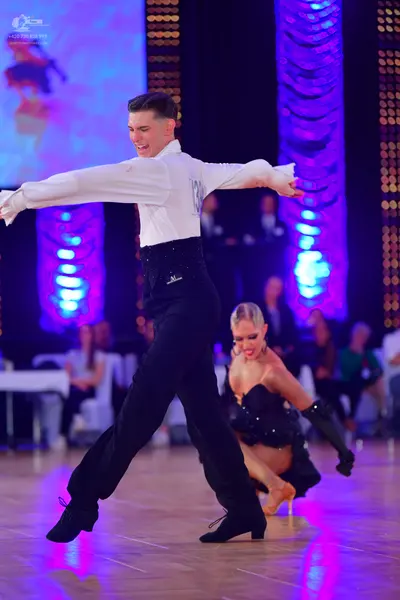 Dancesport competitor: Male dancer: white long-sleeved shirt and black trousers