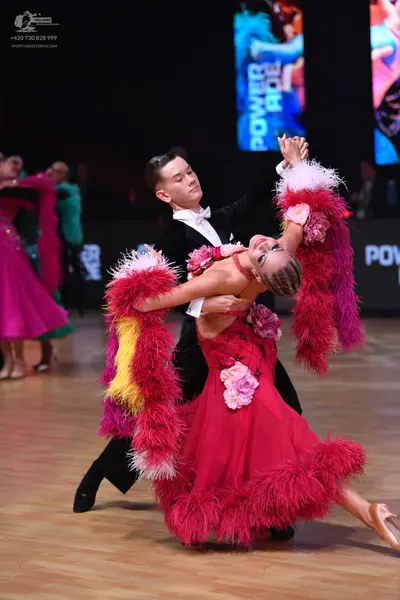 Dancesport competitor: Male dancer: black suit with a white shirt and white bow tie
