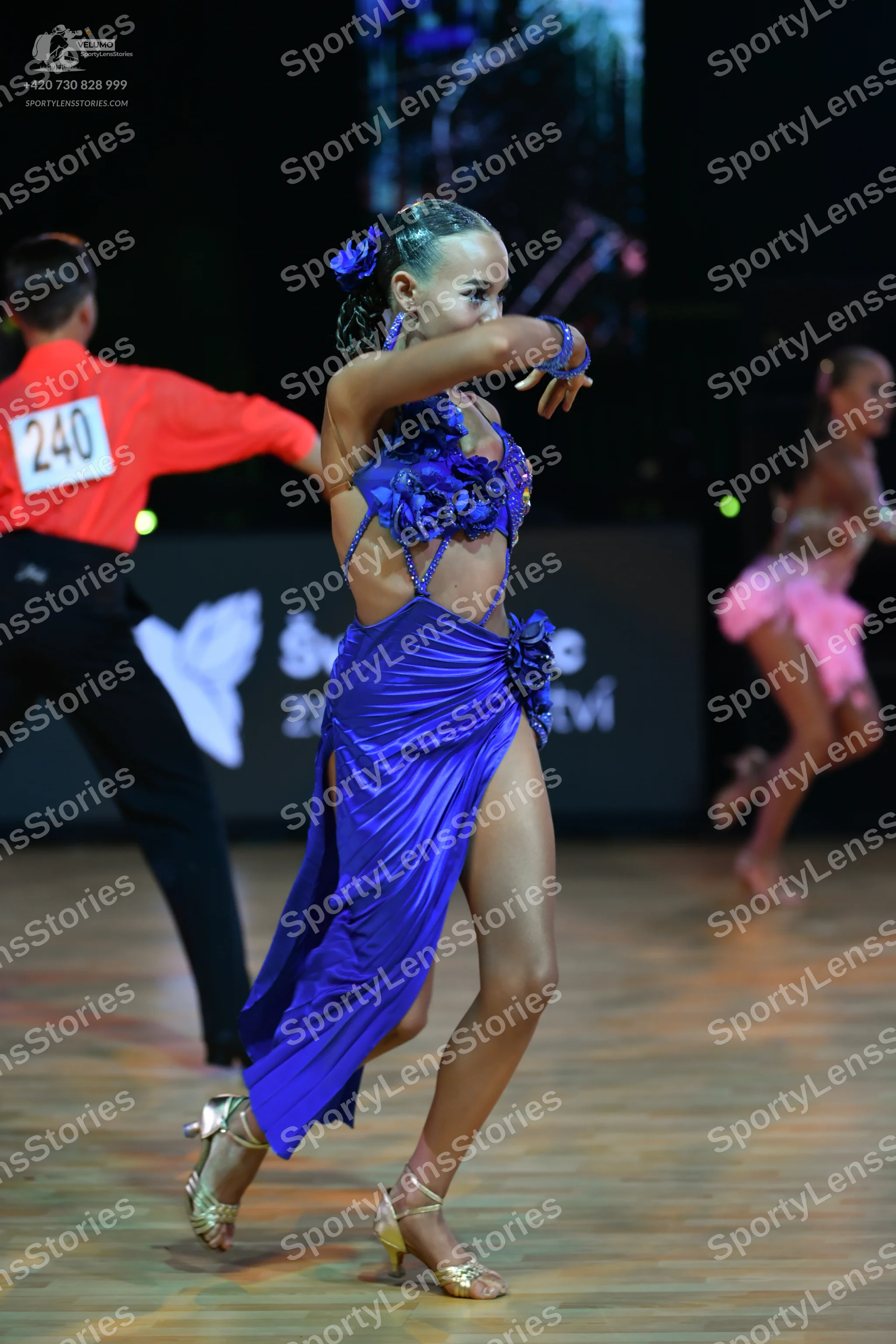 Dancesport competitor: Male dancer: orange long-sleeved shirt and black trousers
