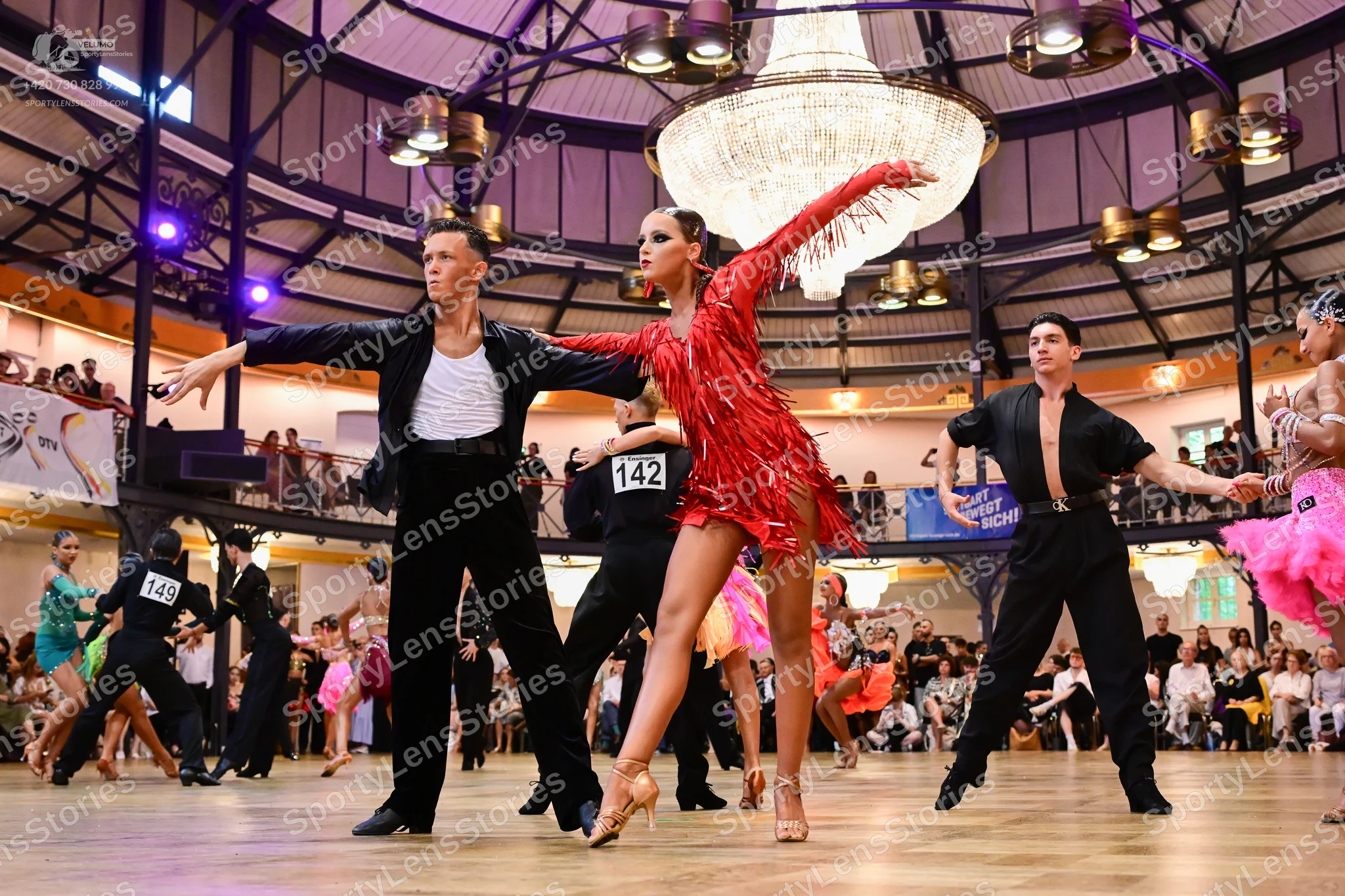 Dancesport competitor #142, #149: Male dancer (center): black jacket, white shirt, and black trousers
