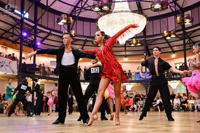 Dancesport competitor #142, #149: Male dancer (center): black jacket, white shirt, and black trousers