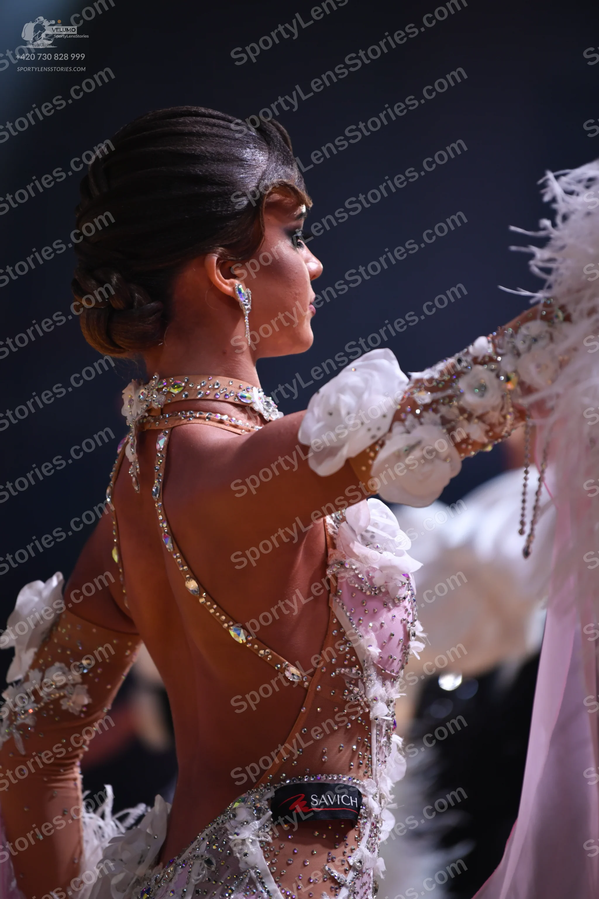 Dancesport competitor: Female dancer: pale pink and nude-colored Latin dress with heavy rhinestone and 
