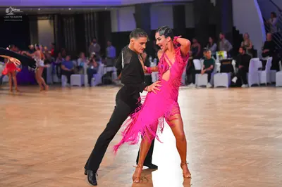 Dancesport competitor: Male dancer: black long-sleeved shirt and black trousers