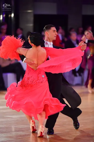 Dancesport competitor: Male dancer: black suit with a white shirt and black shoes