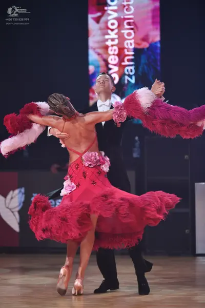 Dancesport competitor: Male dancer: black suit with a white shirt and white bow tie